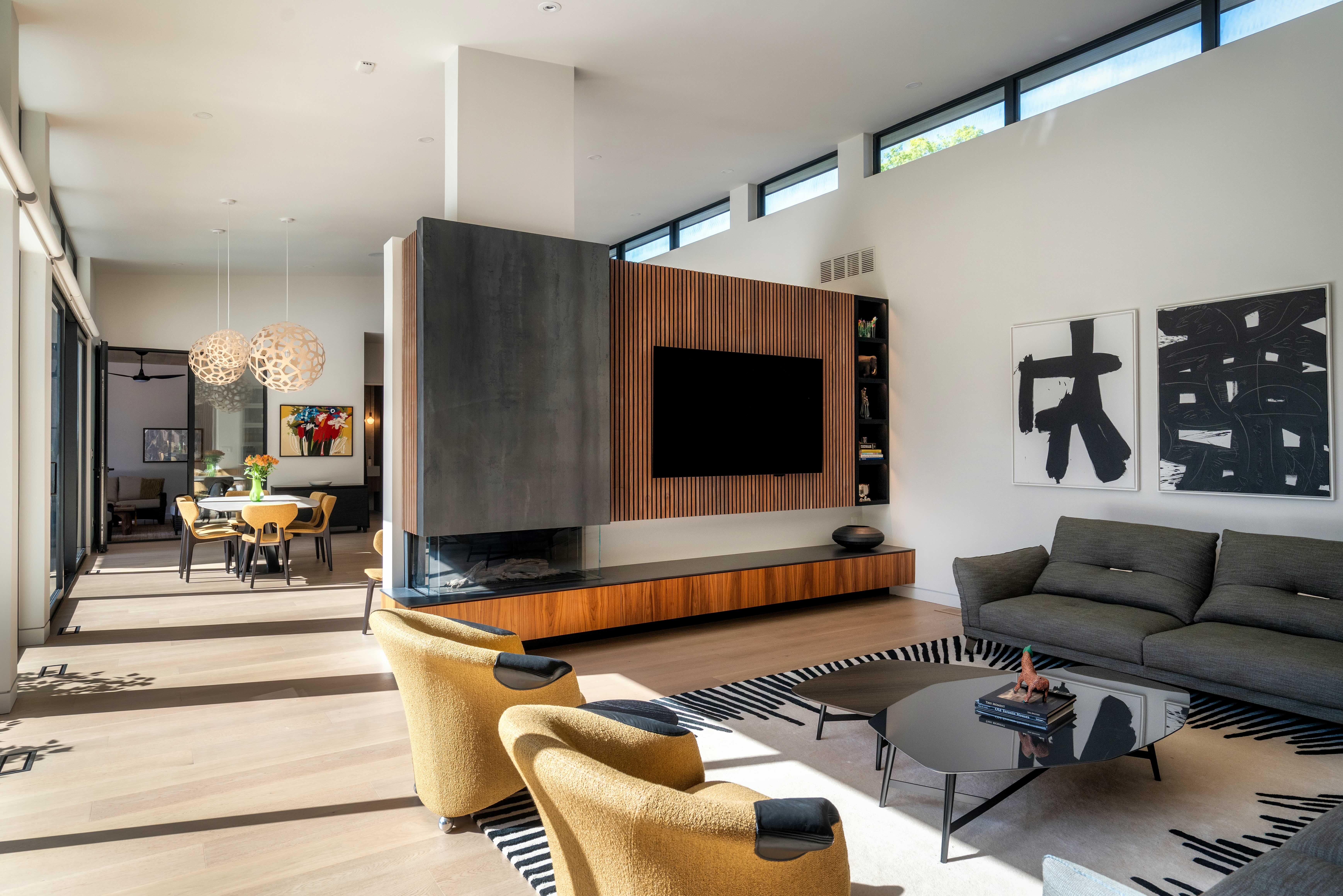 Living space with fireplace volume and slatted wall